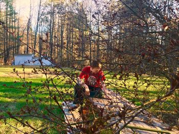 People sitting on tree trunk in forest