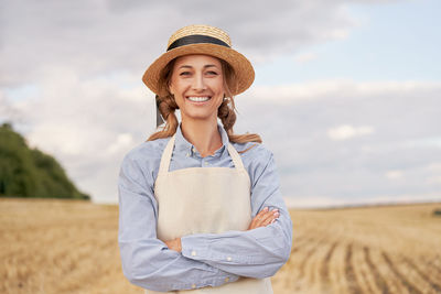 Portrait of a smiling young man standing in field