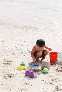 Boy playing with toy on beach