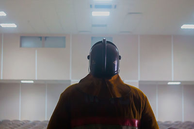 Man standing in illuminated room