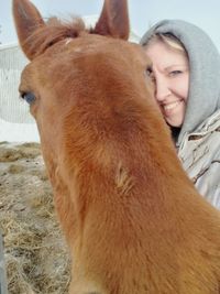 Portrait of young woman with horse