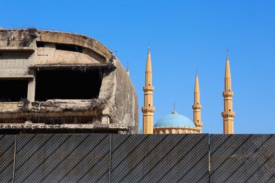 Low angle view of building against clear blue sky