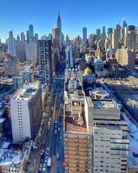 High angle view of modern buildings in city against sky