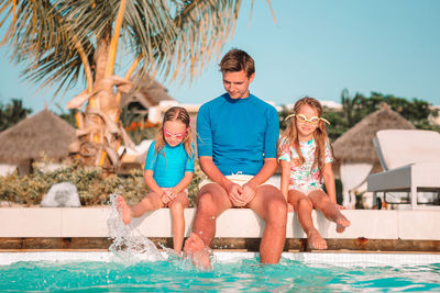 High angle view of people sitting at swimming pool