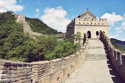 Steps leading towards temple against sky