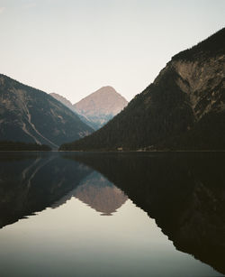 Early morning reflection at plansee in austria. shot on analog kodak portra 400 medium format film.