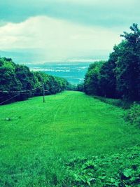 Scenic view of landscape against cloudy sky