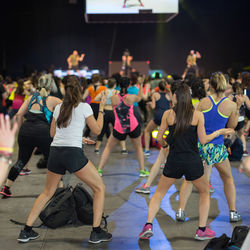 Rear view of people dancing at music concert