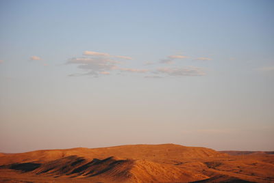 Scenic view of desert against sky during sunset