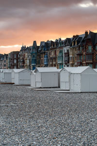 Residential buildings against sky during sunset