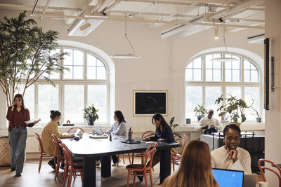 Multiracial team of male and female business professionals working at coworking office