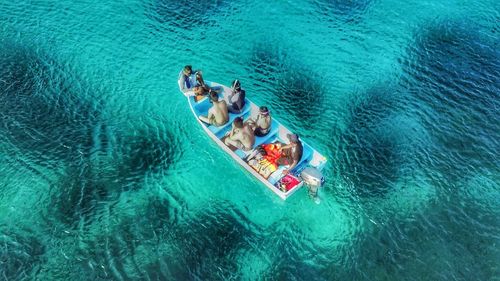 High angle view of people enjoying in swimming pool