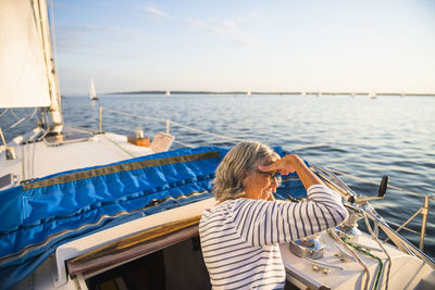 Woman on beach by sea against sky