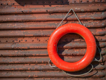 Close-up of life belt hanging on rusty metal