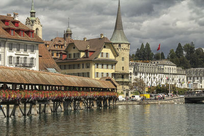 View of buildings in city against cloudy sky