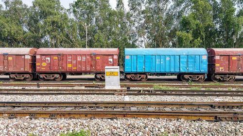 Train by railroad tracks against sky