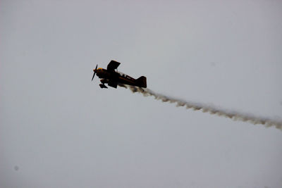 Low angle view of airplane flying against clear sky