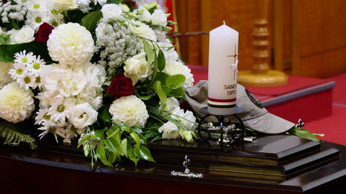 Closeup shot of a funeral casket or coffin in a hearse or chapel or burial at cemetery
