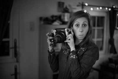 Portrait of young woman photographing
