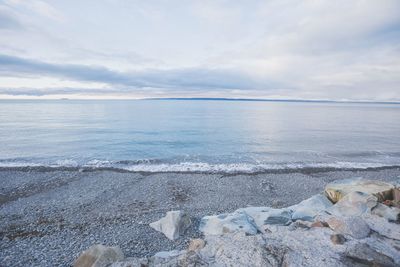 Scenic view of sea against cloudy sky