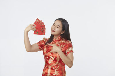 Young woman smiling against white background