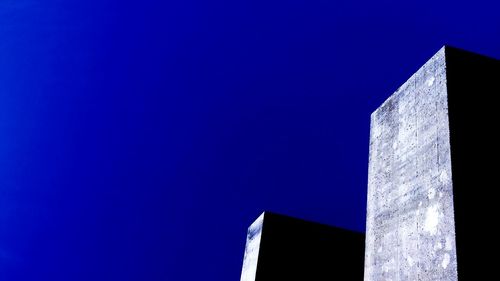 Low angle view of built structure against clear blue sky