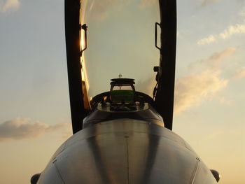 Low angle view of airplane against sky during sunset