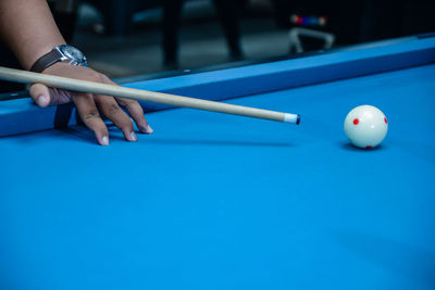 Cropped hand playing pool