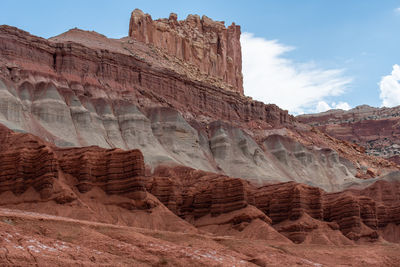 Capitol reef national park low angle landscape of pink, orange and purple barren stone hillside 