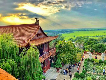 Panoramic view of people outside building against sky