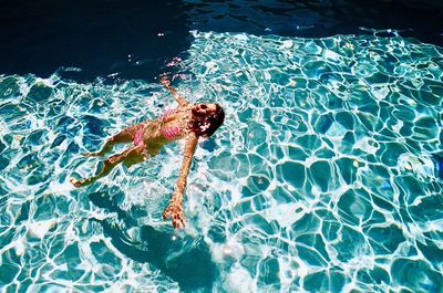 High angle view of woman swimming in pool