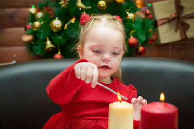 A small child sits the new year festive table.