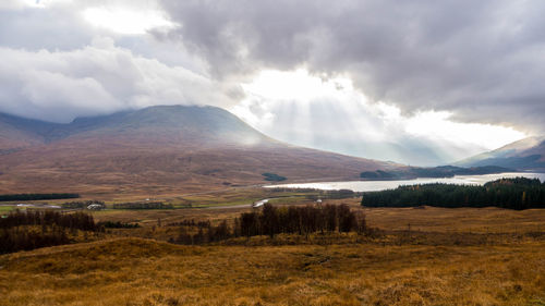 Scenic view of landscape against cloudy sky