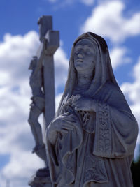 Low angle view of statue against cloudy sky