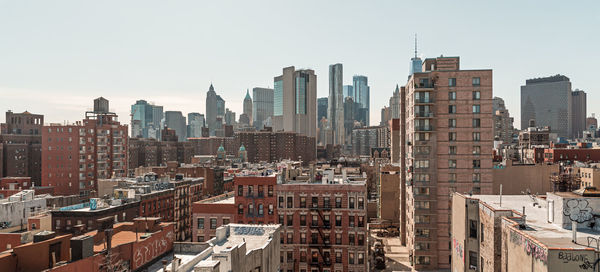 Modern buildings in city against clear sky