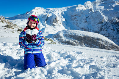 Rear view of woman skiing on snow covered mountain