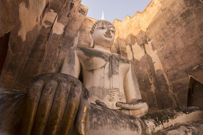 Low angle view of statue against building