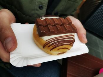 Midsection of person holding chocolate cake