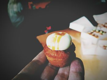 Close-up of hand holding cake