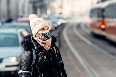 Portrait of woman standing on street in city