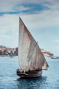 Sailboat sailing on sea against sky