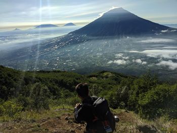 Rear view of man standing on mountain