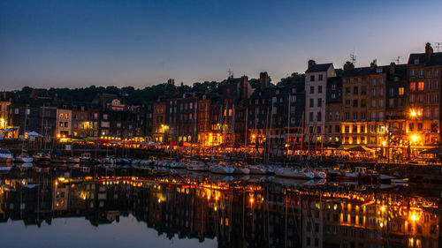 Reflection of illuminated buildings in water at night