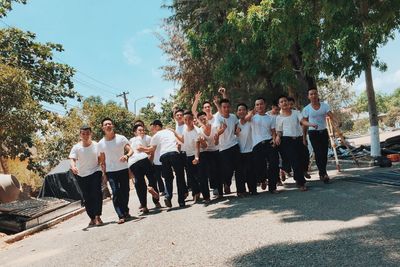 Group of people standing against trees