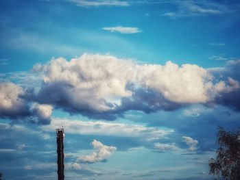 Low angle view of tower against blue sky