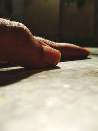Close-up of person hand on floor