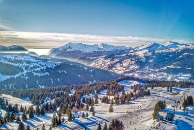 Aerial view of snowcapped mountains against sky