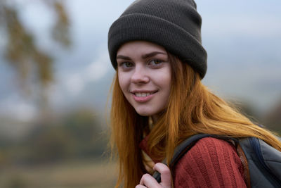 Portrait of smiling woman in hat