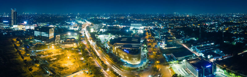 High angle view of city lit up at night