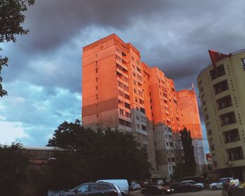 Cars on street amidst buildings against sky